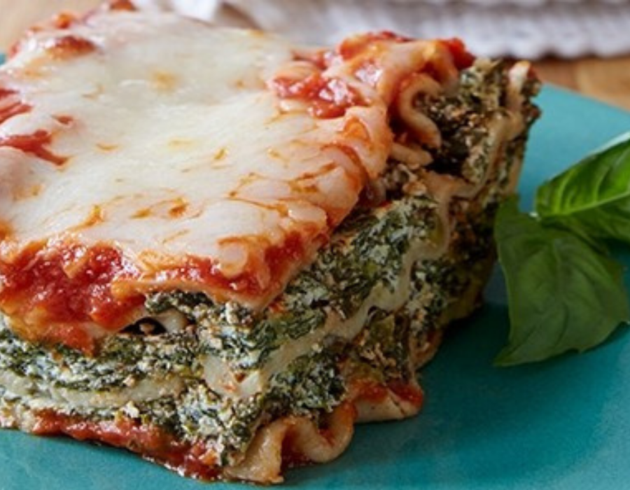 lasagna with spinach square with basil lead next to it