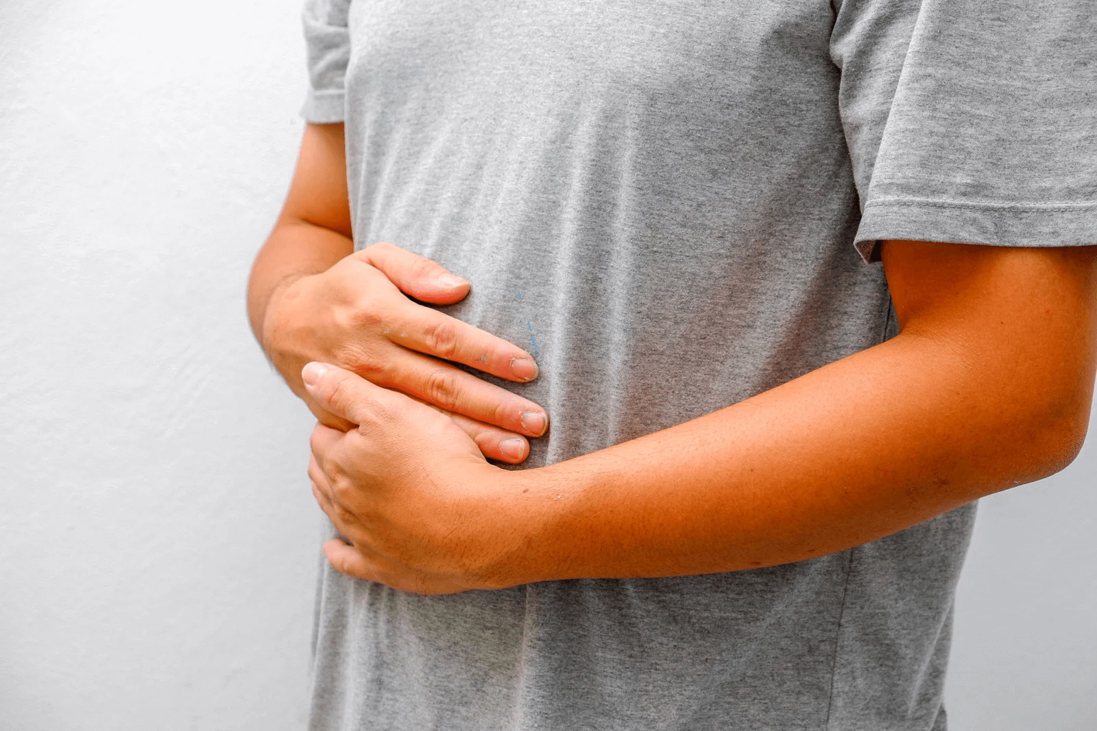 man holding stomach gi nutrition issues person holding stomach in pain due to gastrointestinal nutrition issues