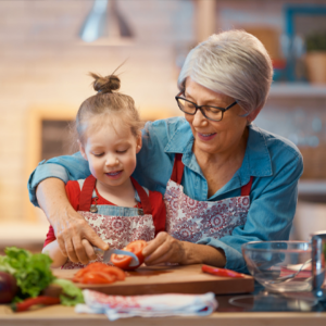 grandmother and child enjoying preparing vegetables together