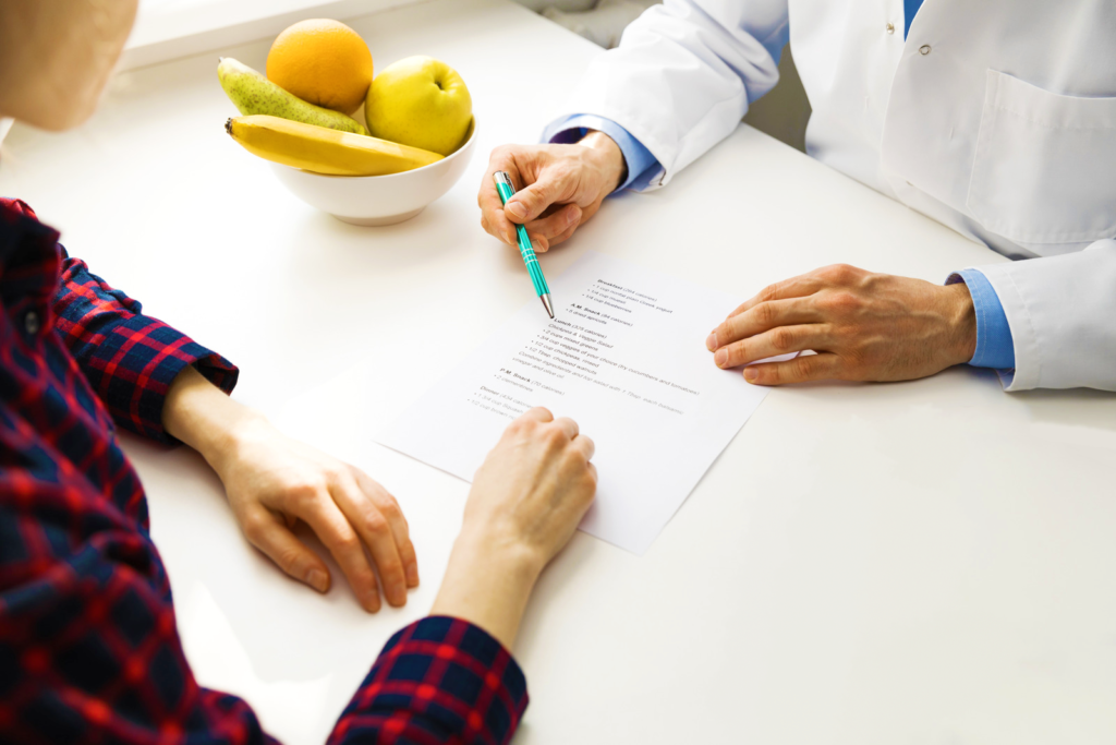 patient with gi conditions going over custom diet plan to limit stomach pain