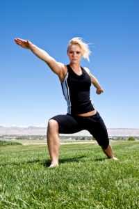 woman exercising to avoid acid reflux on grass