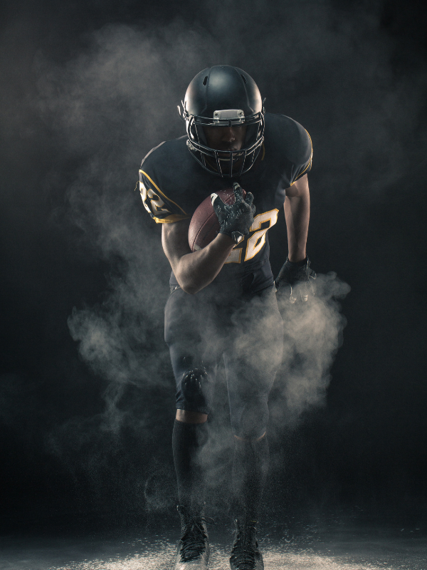 football player at night with smoke energized after proper nutrition