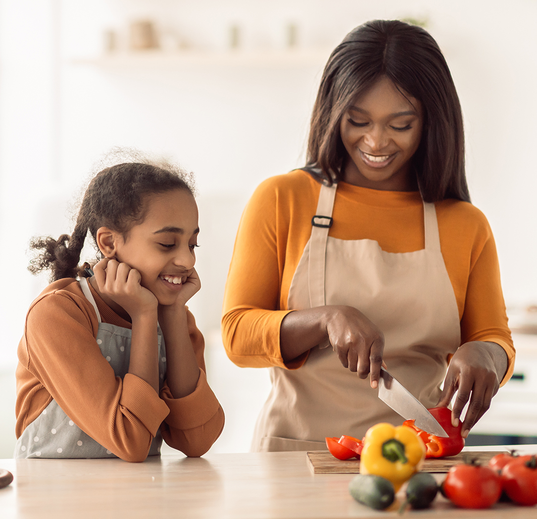 mother teaches her daughter about proper nutrition and how to cook for food allergies