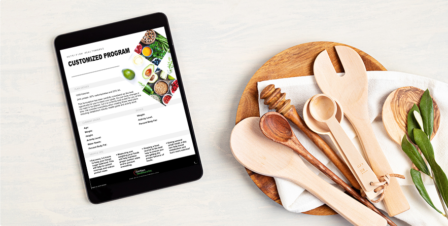 utensils and ipad with customized meal plan on it