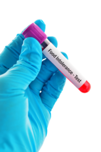 hand holding a test tube labeled food intolerance test