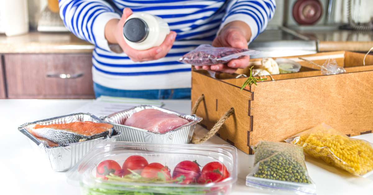 woman unpacking meal prep delivery items