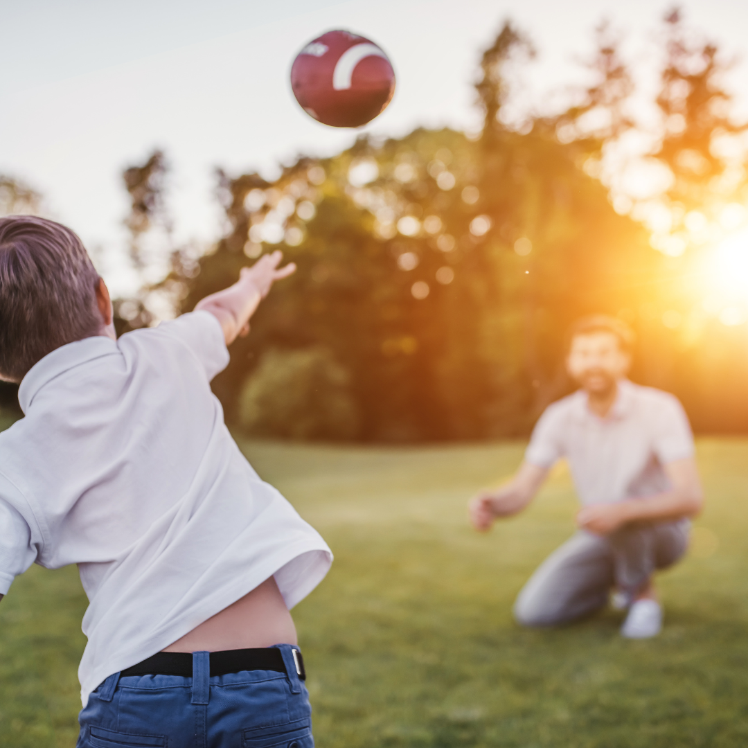 kid playing football with dad on football sunday