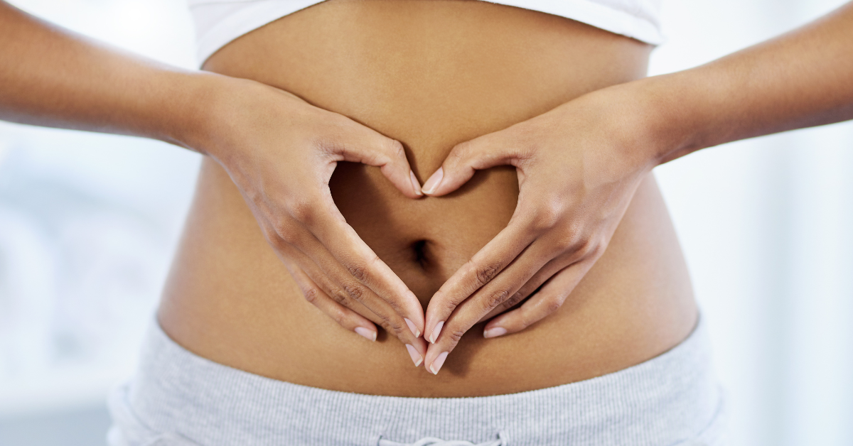 heart hands healthy gut client doing heart hands over stomach showcasing a healthy gut