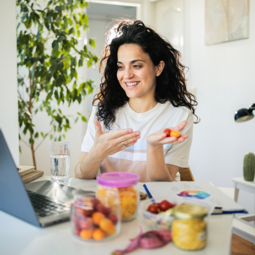 registered dietitian talking to a client over a counter filled with gut-friendly ingredients registered dietitian talking to a client over a counter filled with gut-friendly ingredients