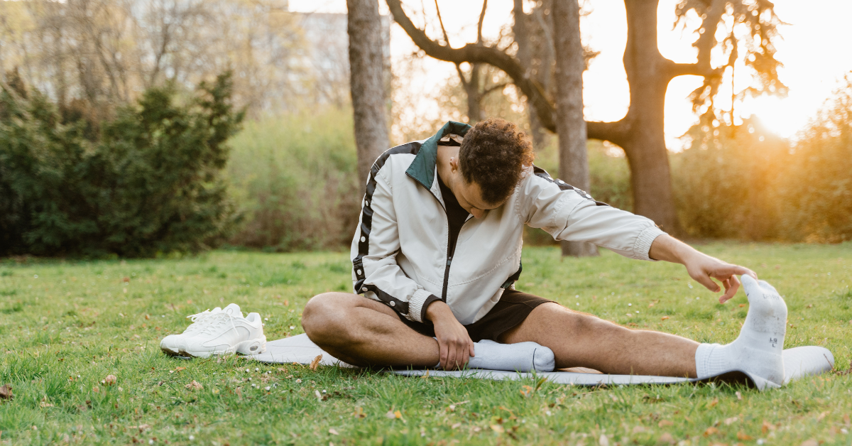 person stretching in the park working on weight management