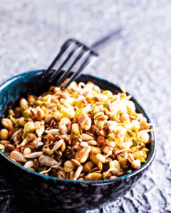 small bowl filled nuts close-up of a small bowl filled with almonds, walnuts, and pistachios