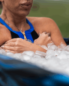 Woman sitting in ice bath for recovery