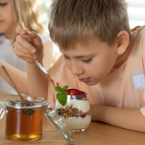 kids eating yoghurt parfait with breakfast tea