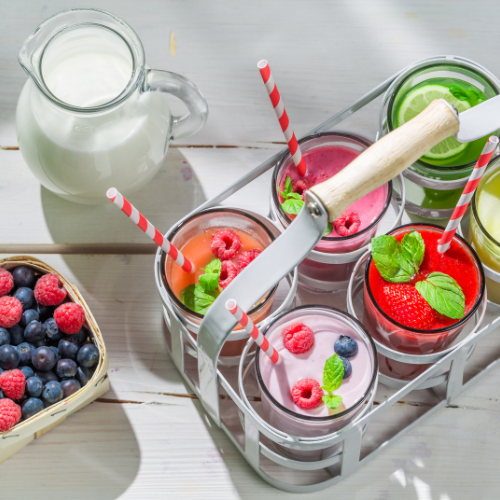 quick healthy breakfast smoothie in smoothie tray with milk, blueberries, and raspberries