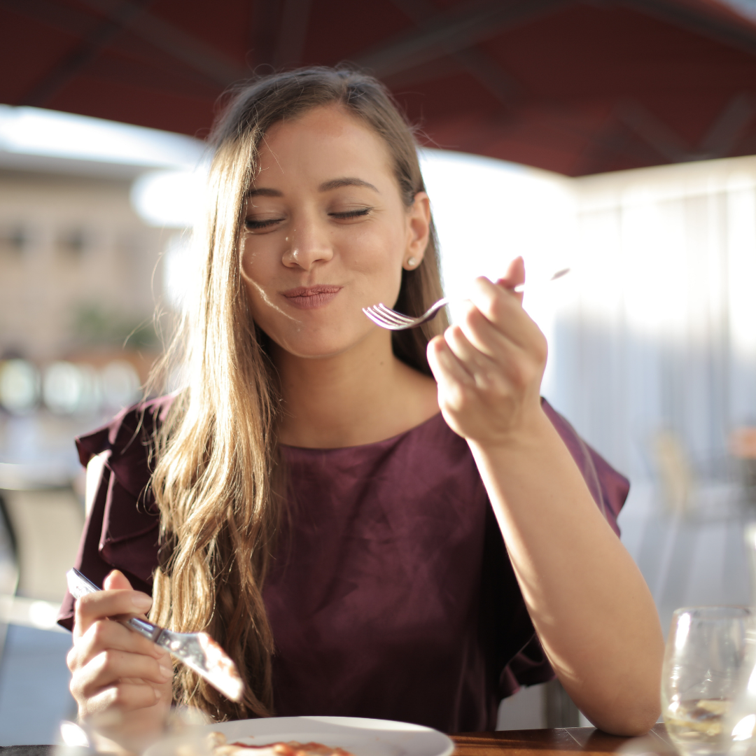 woman taking bite protein rich food woman taking bite of protein rich food