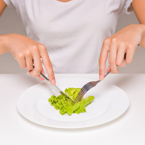 woman cutting up lettuce testing elimination diet